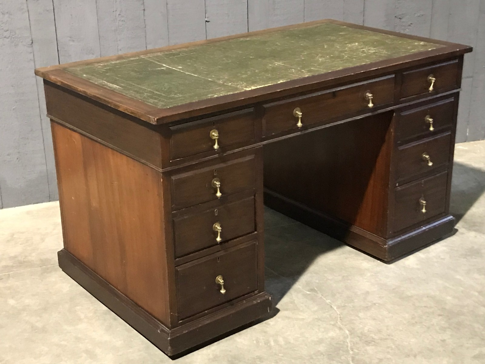 Mahogany english desk with drawers with green leather top 